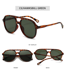 Detail view of double bridge aviator sunglasses in hawksbill green with dark green lenses