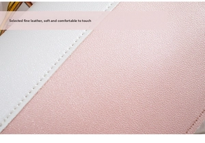 Close-up of pink and white pebbled leather handbag with detailed stitching craftsmanship