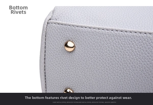 Detail of lavender litchi leather bag base with protective gold metal rivets