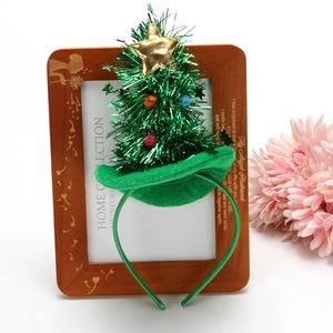 Detail of miniature Christmas tree headband with colorful plush balls and gold star topper