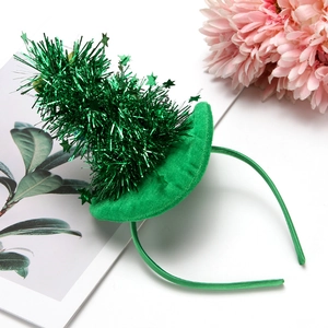 Close-up of green plush Christmas tree headband with sparkling sequins and star topper