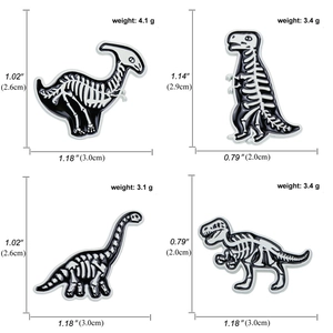 Detailed size chart for black and white dinosaur skeleton enamel pins in four styles