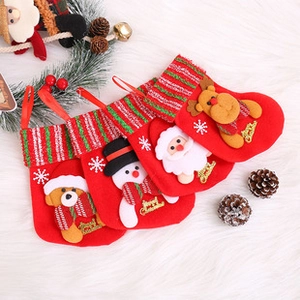 Detailed view of four red Christmas stockings with plush bear, snowman, Santa, and reindeer