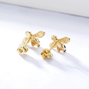 Close-up of S925 silver bee earrings with gold finish and sparkling crystal wings