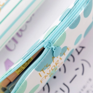 Mint green canvas pencil case with white polka dots and gold text IT'S FAVORITE