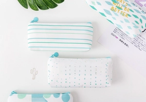 Three canvas pencil cases with green stripes and dots featuring gold foil typography
