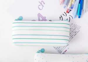 Detailed view of mint green striped canvas pencil case with cute zipper pendant