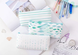 Detailed flat lay of three canvas pencil cases with gold foil motivational patterns