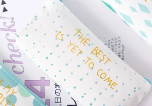 Detail of canvas pencil cases featuring mint green polka dots and gold foil lettering