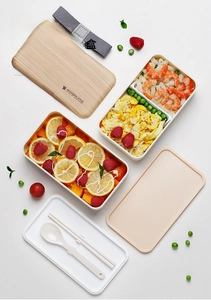 Double-layer bento box with wooden style lid, elastic strap, and cutlery for healthy meals