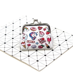Detailed view of white canvas coin purse with colorful unicorn and rainbow cartoon prints