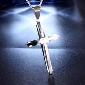 Polished silver stainless steel double layer cross pendant necklace on dark background