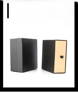 Detail of black textured drawer-style leather belt boxes with gold stamped branding