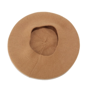 Classic camel wool beret hat with warm knitted texture shown from a top-down view