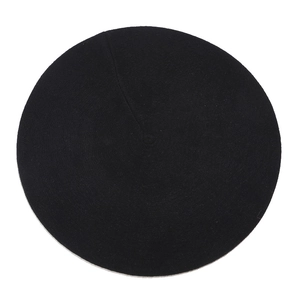 Top-down view of black wool beret showcasing refined felt texture on white background