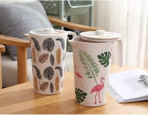 Detail of round bamboo fiber water pitcher featuring tropical leaf and flamingo prints