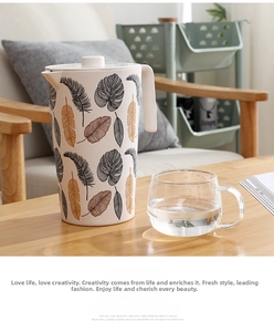 Close-up of bamboo fiber pitcher featuring elegant feather prints on a wooden table