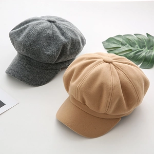 Close-up of wool octagonal newsboy hats in grey and khaki tones with soft texture