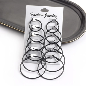 Close-up of 6 pairs set of black hoop earrings in varied sizes on a white display card