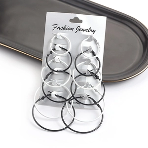 Close-up of 6 pairs set of black and white hoop earrings on display card with a tray