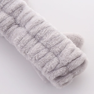 Macro view of the grey plush fabric texture and soft striped pattern on the headband