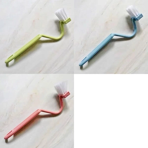 Three-color long-handled L-shaped toilet brushes in pink, blue, and green plastic