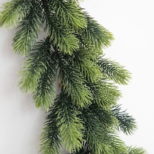 Realistic PE pine needle Christmas garland with natural green gradient on white wall