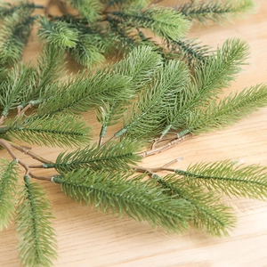 Realistic forest green PE pine needle garland with bionic brown branches for Christmas decor