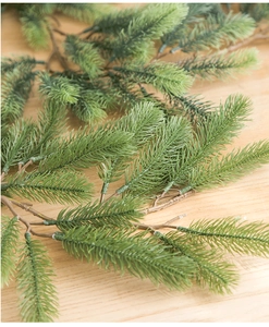 Detailed macro view of lifelike green PE pine needles for Christmas decoration garlands