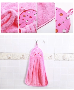 Detail showing plush coral fleece texture and pink hanging hand towel for kitchen use