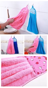 Detail view of pink and blue coral velvet hanging hand towels with cartoon apple patterns