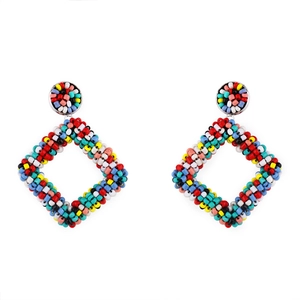 Macro shot of colorful handmade geometric beaded earrings with vibrant bohemian patterns