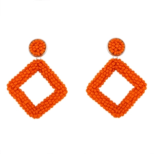 Detailed view of handmade bohemian geometric diamond-shaped orange beaded dangle earrings