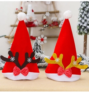 Close-up of red Christmas hats with golden and brown reindeer antlers and snowflake details