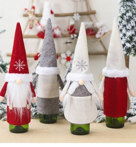 Detailed view of four gnome Christmas wine bottle covers with faux fur and embroidery