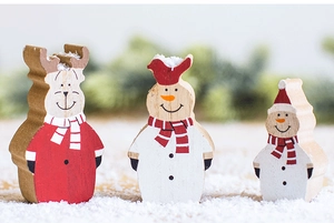 Detailed view of three tiered wooden Christmas reindeer and snowman tabletop figurines