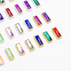 Detailed macro view of colorful rectangular nail art rhinestones with gold metal frames