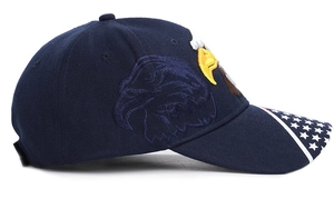 Detailed side view of navy baseball cap with bald eagle embroidery and US flag on brim