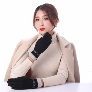 Detail of warm winter gloves with knit windproof cuffs and decorative bow for women