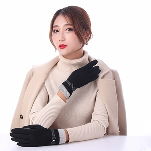 Elegant black winter gloves for women with bow detail and faux fur trim on model
