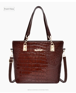 Front view of a dark brown crocodile pattern patent leather tote bag with gold logo