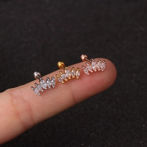 Three mini floral cartilage studs in silver, gold, and rose gold with marquise zircons