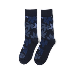 Close-up of deep blue cotton crew socks featuring intricate maple leaf jacquard patterns