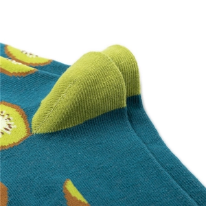 Macro detail of knitted socks featuring realistic kiwi fruit pattern and green toe seam