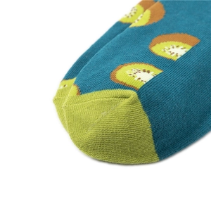 Macro shot of combed cotton socks featuring a detailed kiwi fruit print in dark teal color