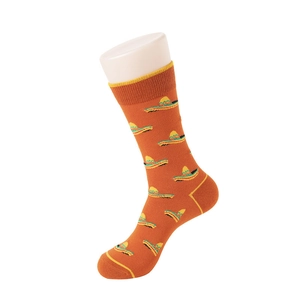 Detail of orange cotton socks with yellow sombrero pattern on a white mannequin