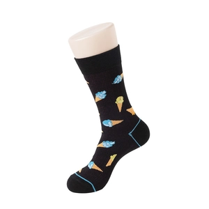 Close-up of black crew socks with blue and yellow ice cream patterns in fine knit