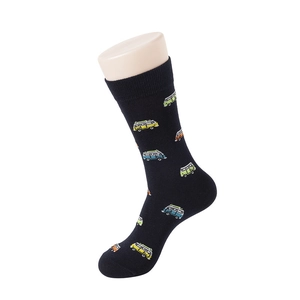 Detail of dark blue crew socks with colorful cartoon camping van patterns on a foot model
