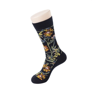 Detail of navy blue cotton socks with orange floral pattern on a mannequin foot