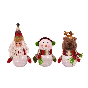 Three Christmas candy jars featuring Santa, Snowman, and Reindeer with clear round bases